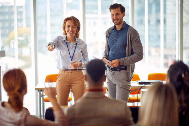 istock Businesspeople discussing project at presentation in  the conference 1354448395