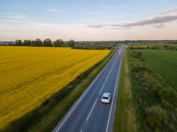 aerial view of car moving by speedway aerial view of car moving by speedway blurred motion drone car on road stock pictures, royalty-free photos & images