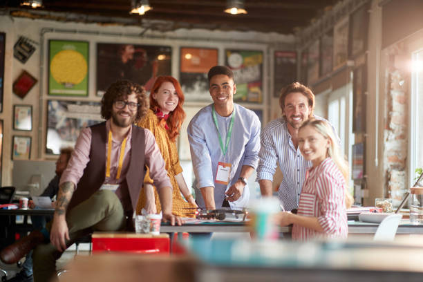 istock Group of young creative people in the office is posing for a photo while working together 1354458089