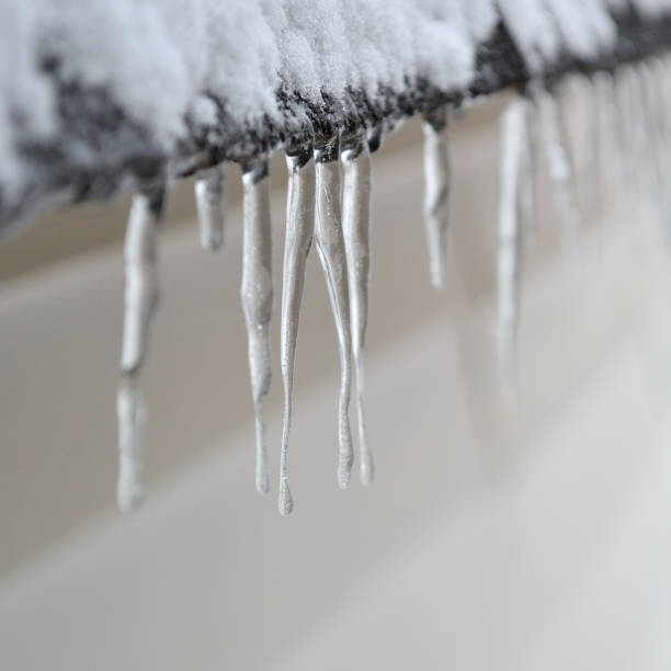 Icicle hanging from a roof in winter stock photo