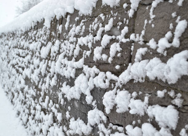 Snowy stone wall stock photo