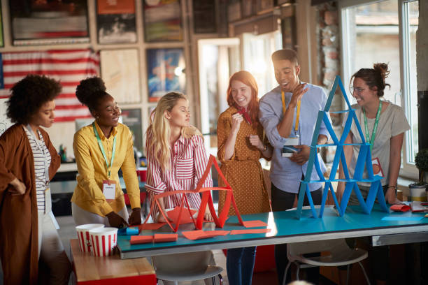 istock Group of young creative people is enjoying playing during a break in the office 1354460103