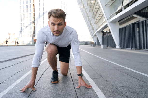 istock Young athlete standing in starting position for running 1354462036