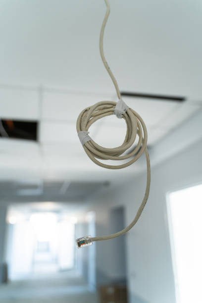 istock Newly built apartment before repairmen. Selective focus on concrete ceiling with electricity cables 1354463626