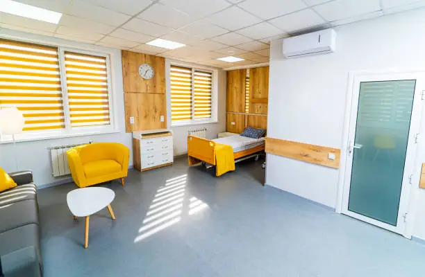 Ward in a hospital for one patient and his visitors. Comfortable and cozy room in the hospital for recovering patient after a surgery or labors.