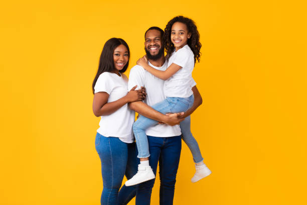 istock Happy black man posing with wife and smiling daughter 1354464652