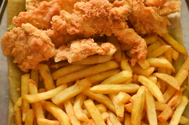 fried chicken and french fries food background fried chicken and french fries food background chicken finger stock pictures, royalty-free photos & images