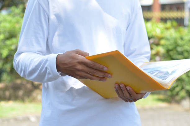 istock male hands reading document gesture in outdoor view 1354468246