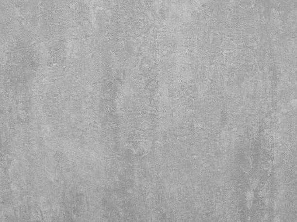 gray wall. The texture of a gray wall. Abstract background with grey plaster texture. Light grey decorative porcelain stoneware or non-woven or paper wallpaper for walls