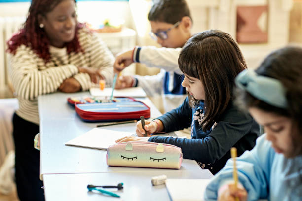 istock Schoolchildren Working on Drawings in Classroom 1354471994