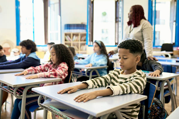 istock Elementary School Children Enjoying Relaxing Quiet Time 1354472032