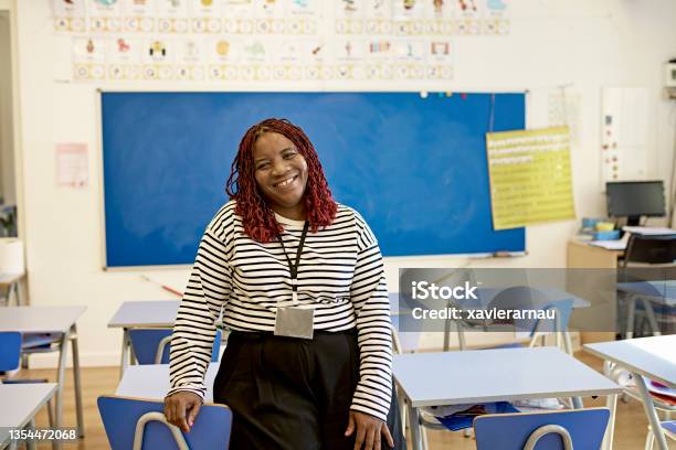 Classroom Portrait Of Cheerful School Teacher Stock Photo - Download Image Now - Teacher, Classroom, Education