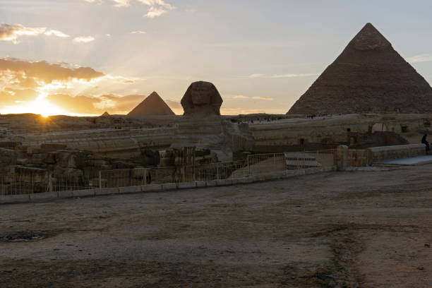 istock Sphinx, Pyramids of Khafre and Menkaure and beautiful sunset 1354472071