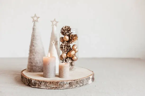 Christmas table decoration with candles and handmade minimalist christmas trees. Festive interior design, easy and cheap diy centerpiece idea.