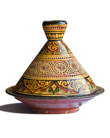 From the North African Cuisine : tagine pot entirely formed of heavy clay, painted and glazed.