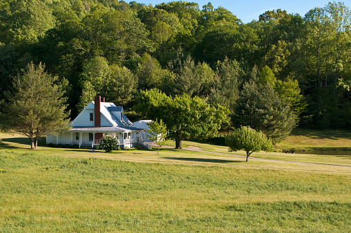 A farmhouse with a wrap around porch in a secluded valley in western Virginia.