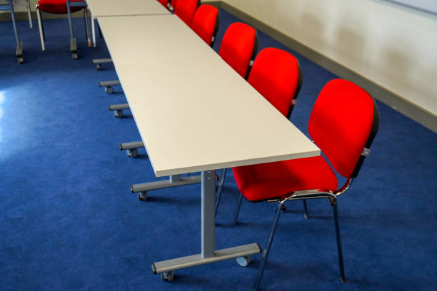 istock Red school classroom chairs and desks 1354479917
