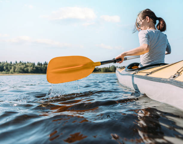istock Young woman is sailing on a boat on the river. 1354480757