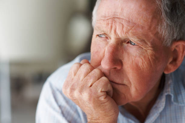 Elderly man lost in thought Elderly man lost in thought hand on chin stock pictures, royalty-free photos & images