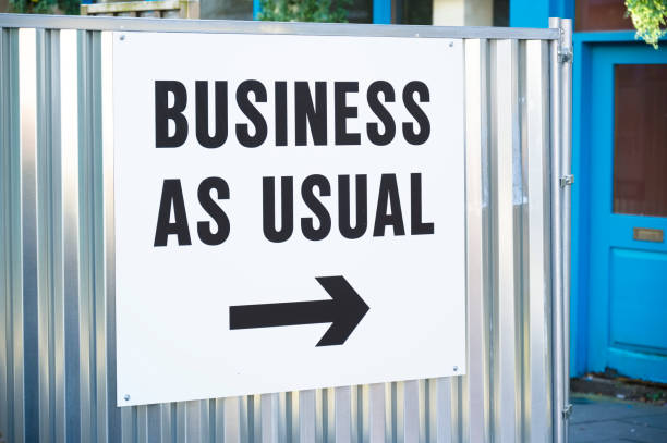 Business as usual open sign with direction arrow UK