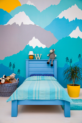 boy bedroom with a beautiful turquoise and grey mountain wall mural. Interior design