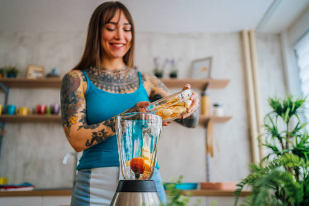 istock Woman preparing fresh fruit smoothie 1354487035