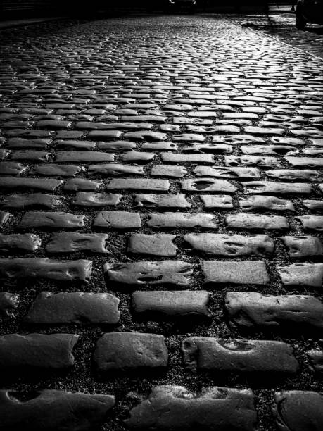 istock old cobbles on the street black and white 1354488325