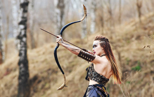 istock Beautiful amazon woman posing with bow 1354488774