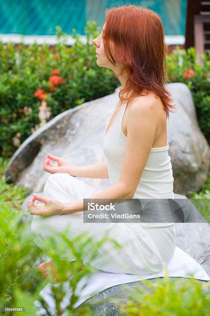 Woman doing yoga exercise outdoors Adult Stock Photo