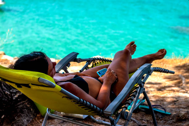 istock The woman sitting at sunbed at cliff 1354492211