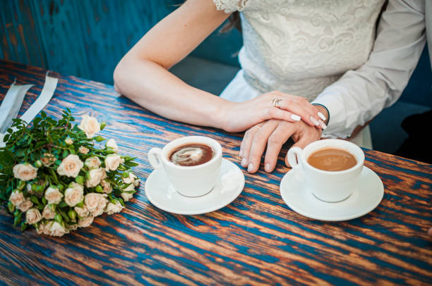 istock Groom and bride with two cups of coffee 1354493309