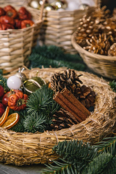 istock Making Christmas door wreath with equipments in decorator's workplace 1354498099