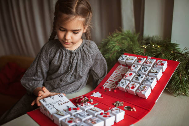 pretty girl holds original advent calendar made of jewelry boxes and binder, christmas diy craft - mobile work imagens e fotografias de stock