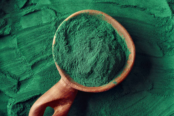istock Green spirulina algae powder on a wooden spoon 1354501326