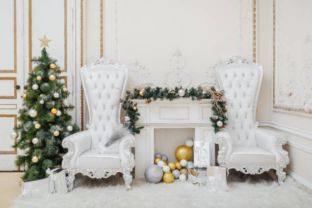 istock Christmas fireplace with comfortable ceremonial royal armchairs 1354503710