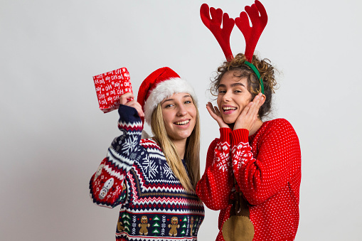 I have a Christmas present for you! Two beautiful women in New Year's sweaters with gifts