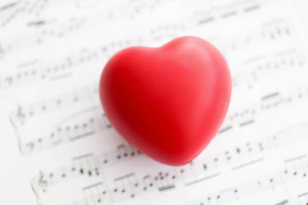 istock Red toy heart lying on paper with notes closeup 1354514630