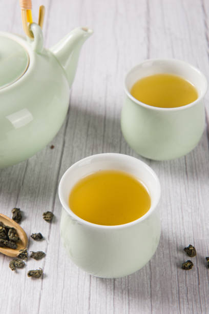 istock green tea with tea cups and teapot on wooden table 1354516689
