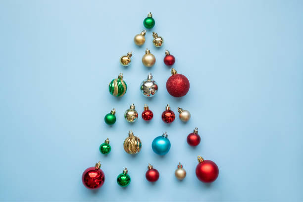 istock Christmas tree from baubles on blue pastel background 1354523728