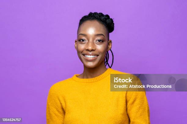 Casual African American Woman Smiling In Purple Studio Isolated Background Stock Photo - Download Image Now