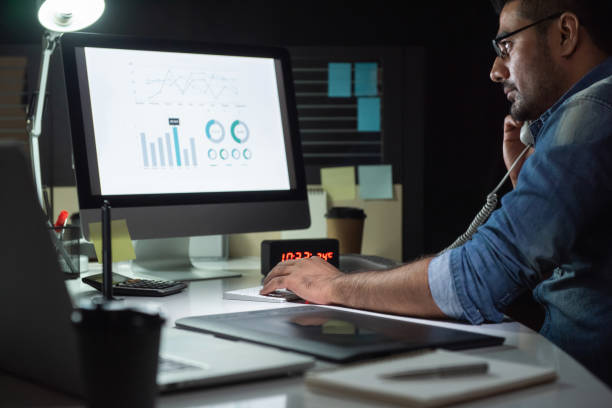 istock Asian man concentrating on working in the office at night 1354524894