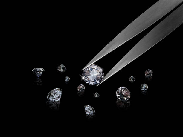 istock Diamond in tweezers on a black background with diamonds group soft focusing 1354527025
