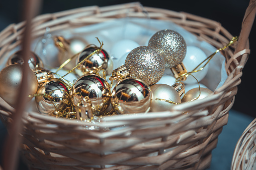 Christmas tree or decorations, Christmas shiny golden and red colours sphere balls in a wooden basket