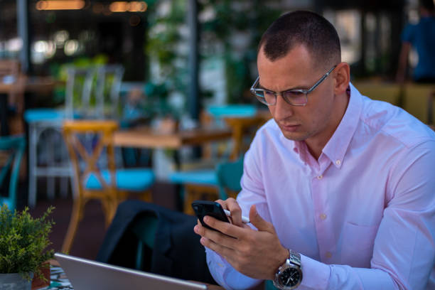 istock Young handsome businessman working on his laptop while sitting in a cafe 1354528663