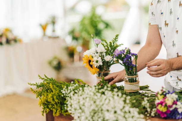 istock Unrecognizable woman making fresh flowers wedding decoration. 1354530325