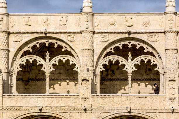 Lisbon, Portugal - December 28, 2008: detail view of window in Jeronimos Monastery Cloister with visitor in Manueline style in Lisbon, Portugal.