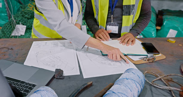 istock Closeup shot of an unrecognisable man and woman going through paperwork while working in a warehouse 1354533644