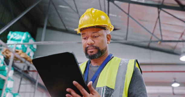 istock Low angle shot of a mature man using a digital tablet while working in a warehouse 1354533673