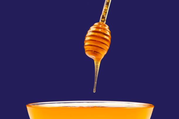 istock fresh fragrant honey dripping from a spoon into a plate on a blue background. organic vitamin nutrition 1354534476