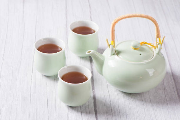 istock black tea with tea cups and teapot on wooden table 1354534510